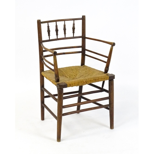 1667 - A late 19thC Arts & Crafts Sussex chair by William Morris. The chair with a spindle turned and doubl... 