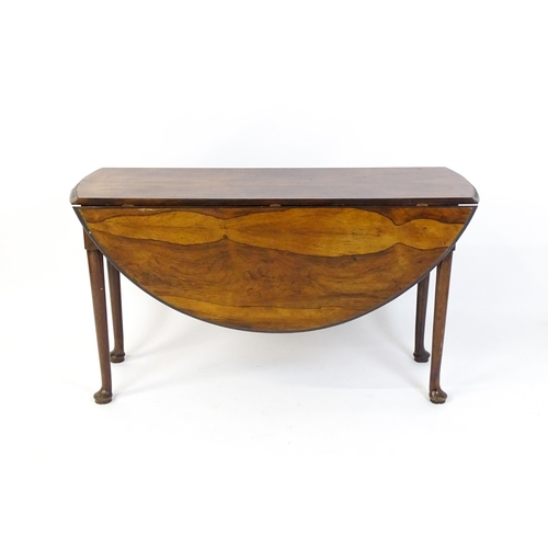 1668 - A 19thC rosewood drop leaf table flanked to each side by a demi lune leaf, the table raised on turne... 