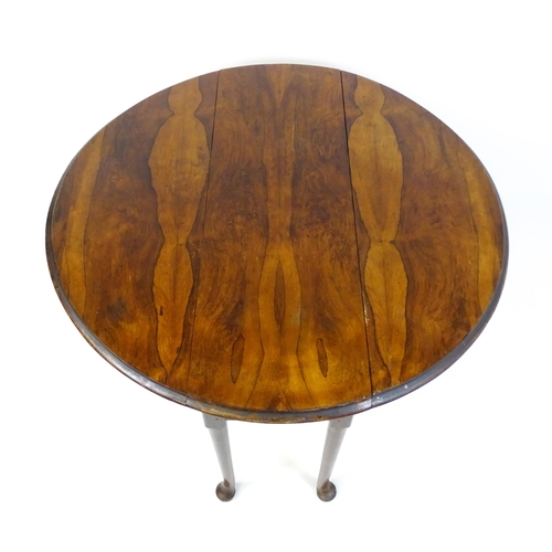 1668 - A 19thC rosewood drop leaf table flanked to each side by a demi lune leaf, the table raised on turne... 