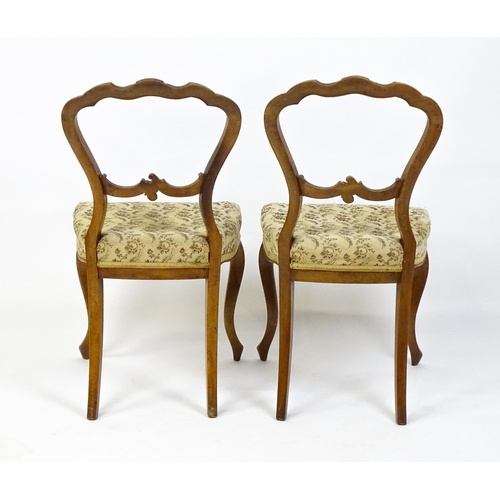 1676 - A pair of late 19thC walnut balloon back bedroom chairs with carved top and mid rails above cabriole... 