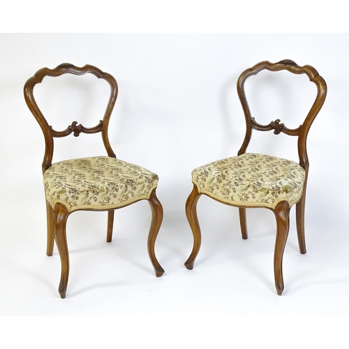 1676 - A pair of late 19thC walnut balloon back bedroom chairs with carved top and mid rails above cabriole... 