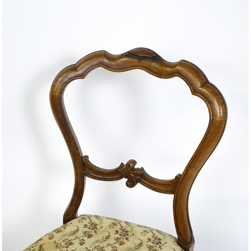 1676 - A pair of late 19thC walnut balloon back bedroom chairs with carved top and mid rails above cabriole... 