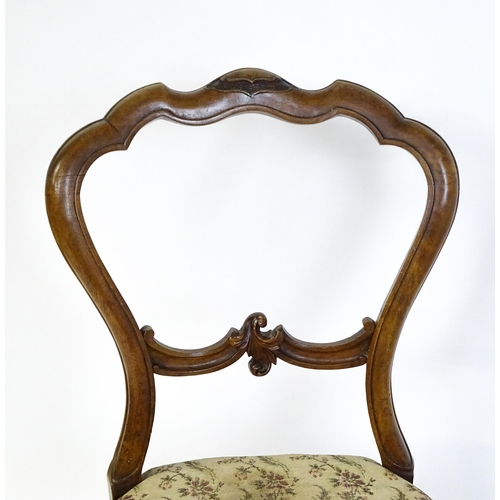 1676 - A pair of late 19thC walnut balloon back bedroom chairs with carved top and mid rails above cabriole... 