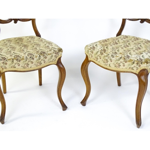 1676 - A pair of late 19thC walnut balloon back bedroom chairs with carved top and mid rails above cabriole... 