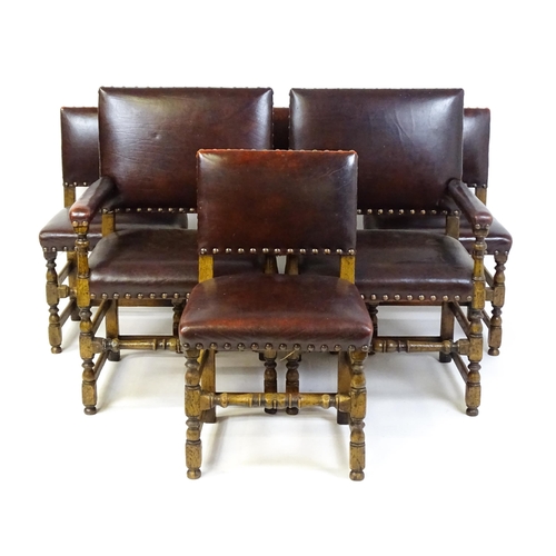 1684 - A set of six early 20thC oak and leather dining chairs with studwork detailing and raised on block a... 