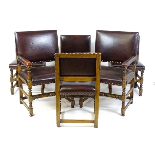 1684 - A set of six early 20thC oak and leather dining chairs with studwork detailing and raised on block a... 