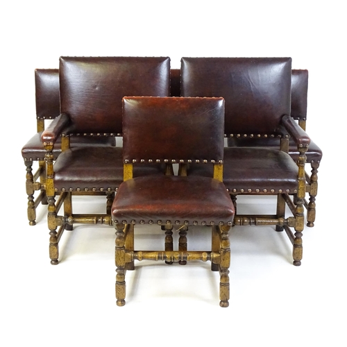 1684 - A set of six early 20thC oak and leather dining chairs with studwork detailing and raised on block a... 