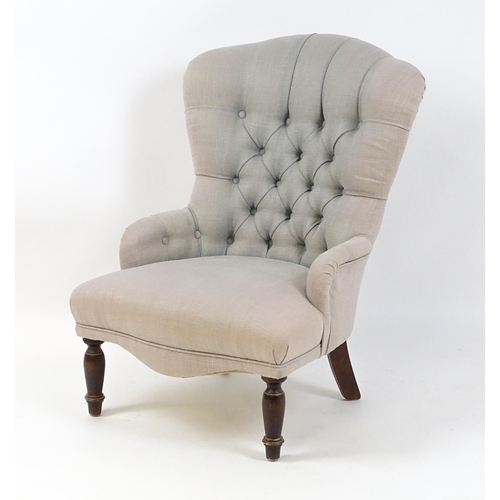 1685 - A late 20thC nursing chair with a deep buttoned backrest, sprung seat and raised on turned tapering ... 