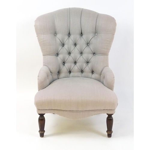 1685 - A late 20thC nursing chair with a deep buttoned backrest, sprung seat and raised on turned tapering ... 