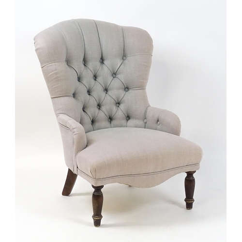 1685 - A late 20thC nursing chair with a deep buttoned backrest, sprung seat and raised on turned tapering ... 