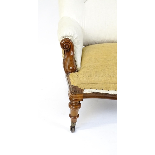 1686 - A Victorian mahogany steel framed armchair with carved, scrolled arms above turned tapering front le... 