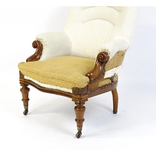 1686 - A Victorian mahogany steel framed armchair with carved, scrolled arms above turned tapering front le... 