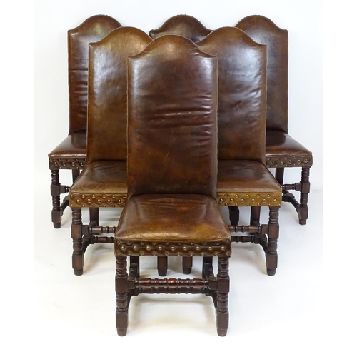 1689 - A set of six 20thC leather covered dining chairs with studwork detailing, the chairs raised on block... 