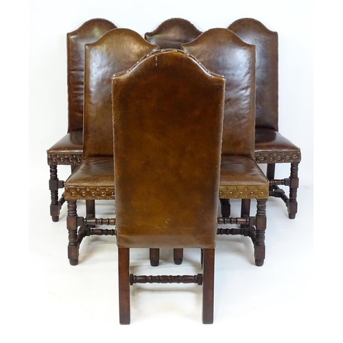 1689 - A set of six 20thC leather covered dining chairs with studwork detailing, the chairs raised on block... 