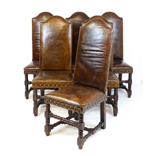 1689 - A set of six 20thC leather covered dining chairs with studwork detailing, the chairs raised on block... 