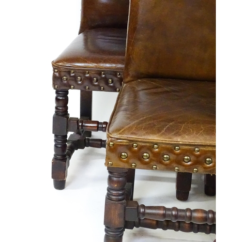 1689 - A set of six 20thC leather covered dining chairs with studwork detailing, the chairs raised on block... 