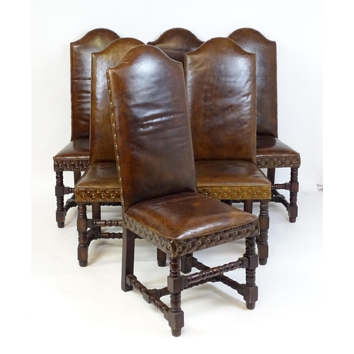 1689 - A set of six 20thC leather covered dining chairs with studwork detailing, the chairs raised on block... 