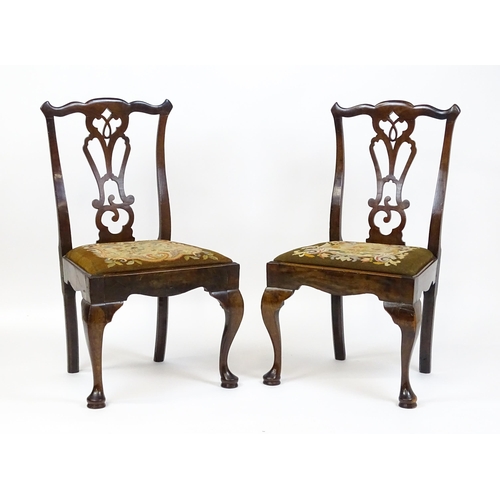 1700 - A pair of early Georgian side chairs with pierced Chippendale back splats above drop in seats and ra... 