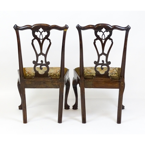 1700 - A pair of early Georgian side chairs with pierced Chippendale back splats above drop in seats and ra... 