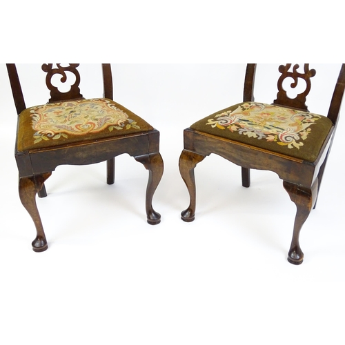 1700 - A pair of early Georgian side chairs with pierced Chippendale back splats above drop in seats and ra... 