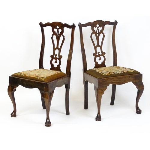 1700 - A pair of early Georgian side chairs with pierced Chippendale back splats above drop in seats and ra... 