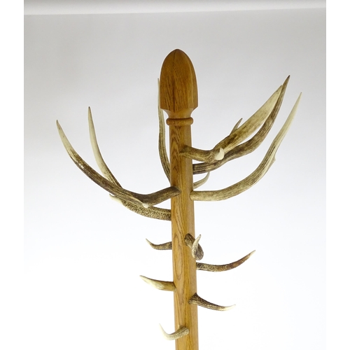 1702 - A late 20thC / early 21stC hall stand with antler coat hooks and a twenty-four section stick stand a... 