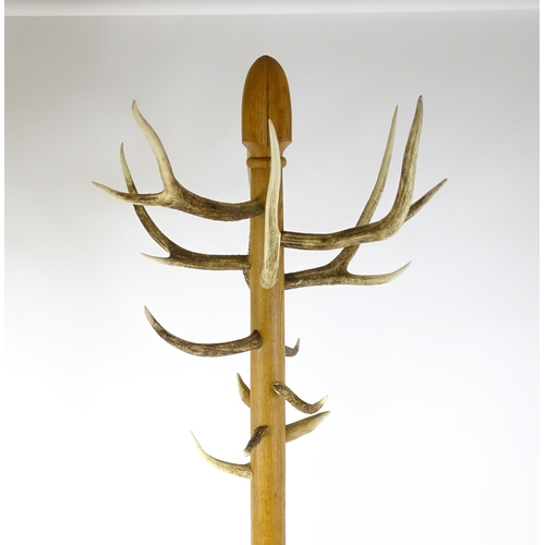 1702 - A late 20thC / early 21stC hall stand with antler coat hooks and a twenty-four section stick stand a... 