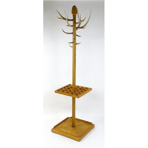 1702 - A late 20thC / early 21stC hall stand with antler coat hooks and a twenty-four section stick stand a... 