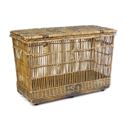 1703 - An early 20thC wicker factory trolley with a hinged lid and raised on six castors. 51