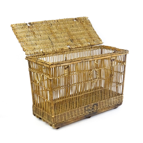 1703 - An early 20thC wicker factory trolley with a hinged lid and raised on six castors. 51