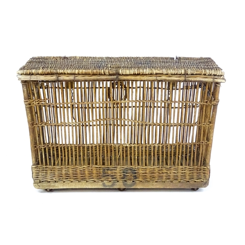 1703 - An early 20thC wicker factory trolley with a hinged lid and raised on six castors. 51