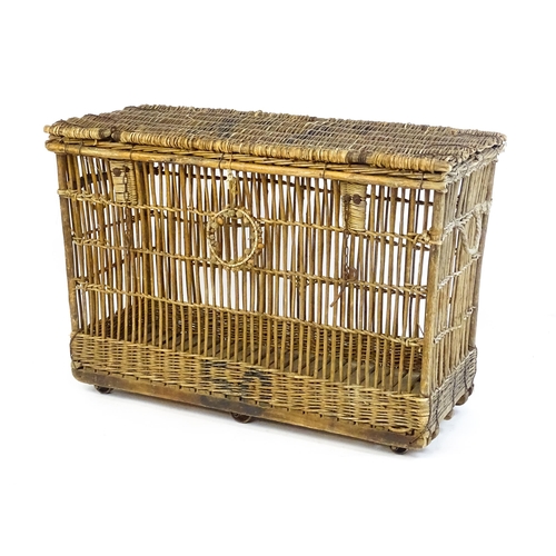 1703 - An early 20thC wicker factory trolley with a hinged lid and raised on six castors. 51