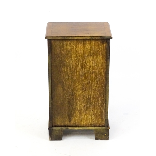 1717 - A late 20thC yew wood bedside cabinet with four short crossbanded drawers with turned wooden handles... 