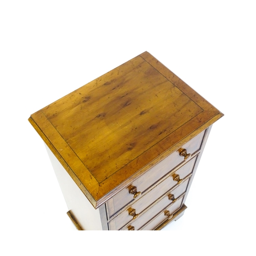 1717 - A late 20thC yew wood bedside cabinet with four short crossbanded drawers with turned wooden handles... 