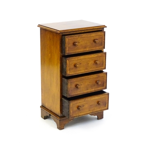 1717 - A late 20thC yew wood bedside cabinet with four short crossbanded drawers with turned wooden handles... 