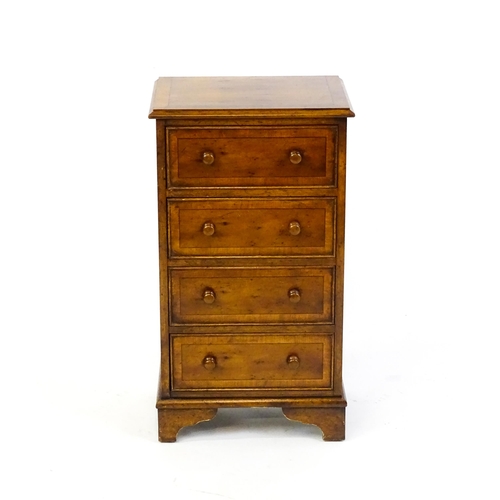 1717 - A late 20thC yew wood bedside cabinet with four short crossbanded drawers with turned wooden handles... 