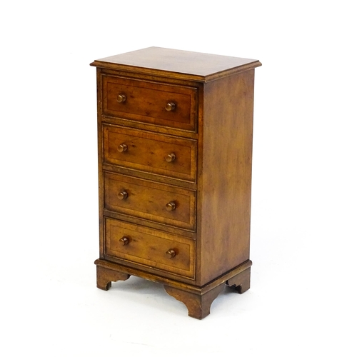 1717 - A late 20thC yew wood bedside cabinet with four short crossbanded drawers with turned wooden handles... 