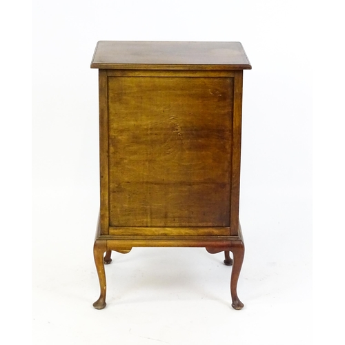 1718 - An Edwardian mahogany music cabinet with six short drawers with fall fronts and raised on four cabri... 