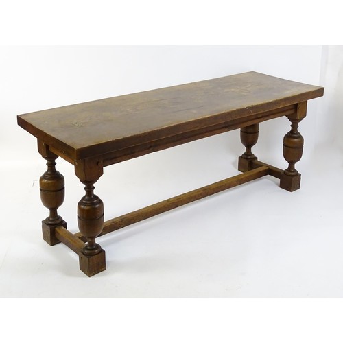 1617 - A late 19thC oak refectory table with a rectangular top above four cup and cover legs united by a H-... 