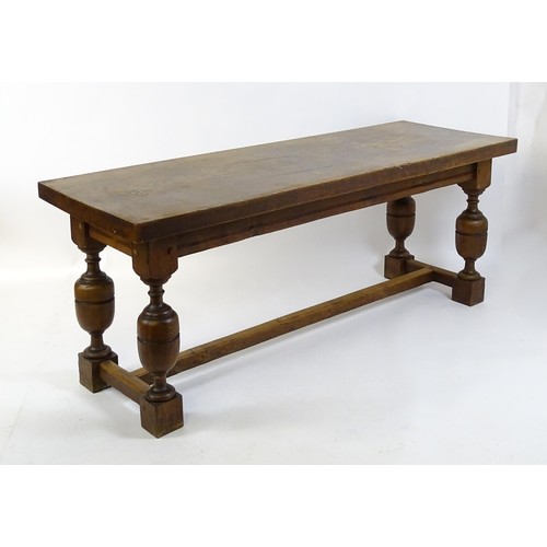 1617 - A late 19thC oak refectory table with a rectangular top above four cup and cover legs united by a H-... 