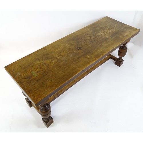 1617 - A late 19thC oak refectory table with a rectangular top above four cup and cover legs united by a H-... 