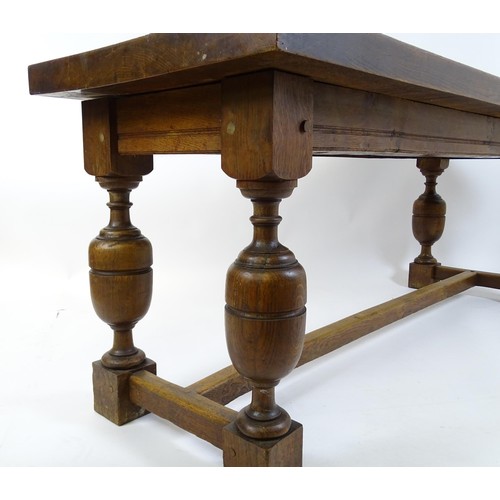 1617 - A late 19thC oak refectory table with a rectangular top above four cup and cover legs united by a H-... 