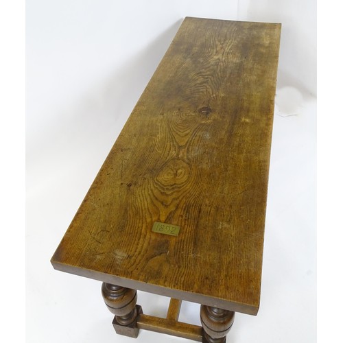 1617 - A late 19thC oak refectory table with a rectangular top above four cup and cover legs united by a H-... 