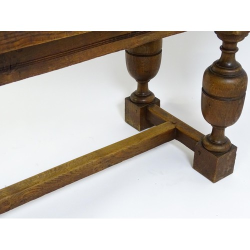 1617 - A late 19thC oak refectory table with a rectangular top above four cup and cover legs united by a H-... 