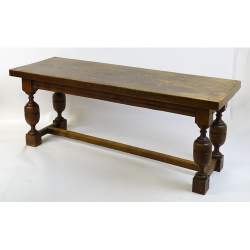 1617 - A late 19thC oak refectory table with a rectangular top above four cup and cover legs united by a H-... 