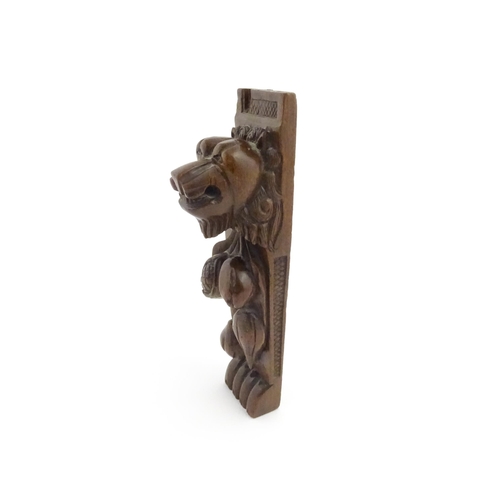 1090 - A 19thC carved mahogany bracket with carved lion mask, fruit and paw decoration. Approx. 12 3/4