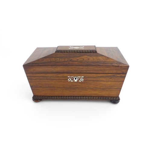 1094 - A 19thC rosewood tea caddy of sarcophagus form with inlaid foliate and foliate mother of pearl detai... 