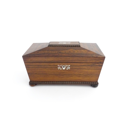 1094 - A 19thC rosewood tea caddy of sarcophagus form with inlaid foliate and foliate mother of pearl detai... 