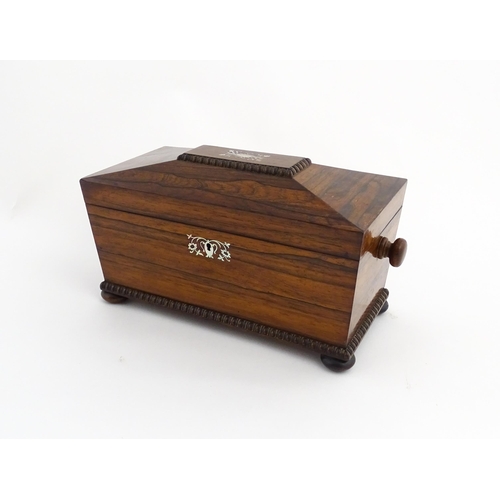 1094 - A 19thC rosewood tea caddy of sarcophagus form with inlaid foliate and foliate mother of pearl detai... 