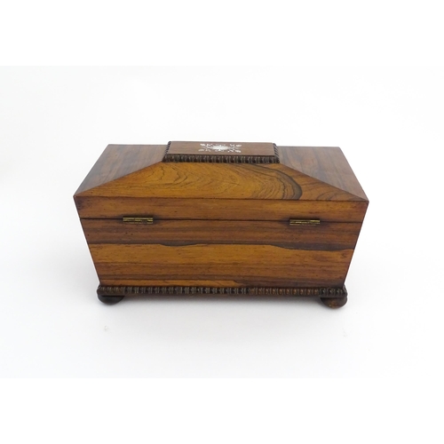 1094 - A 19thC rosewood tea caddy of sarcophagus form with inlaid foliate and foliate mother of pearl detai... 